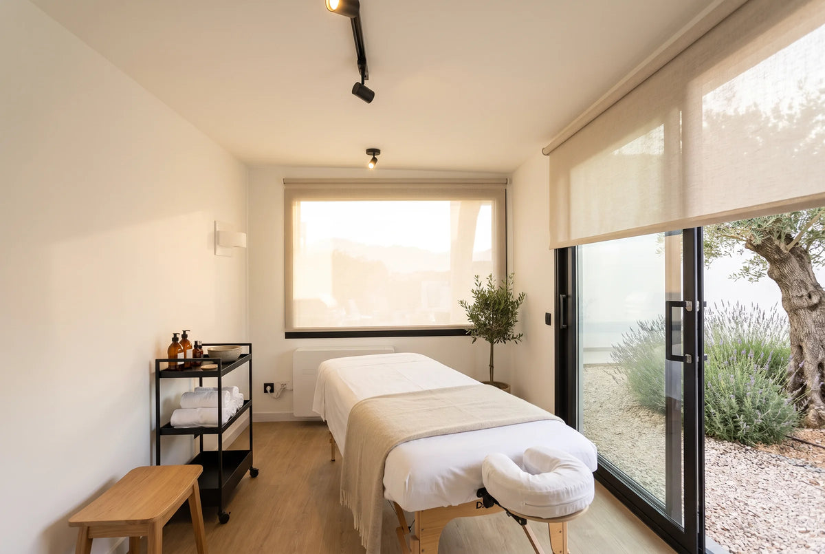 Visualisation of a NOOK 10 set up as a massage room, a table running down the room and the blinds half down