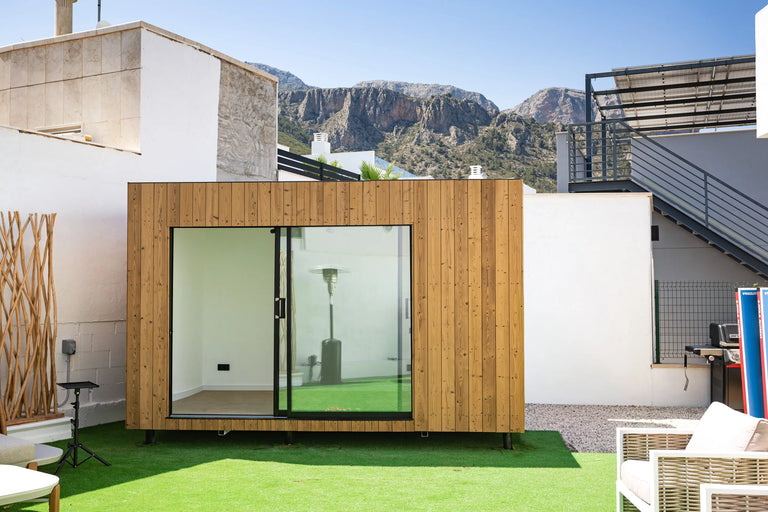 An oak NOOK 10 on its plot, with the mountains behind