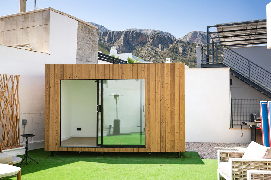 An oak NOOK 10 on its plot, with the mountains behind
